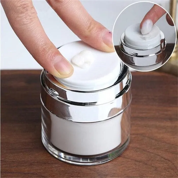 White cream jar vacuum bottle on a bathroom shelf